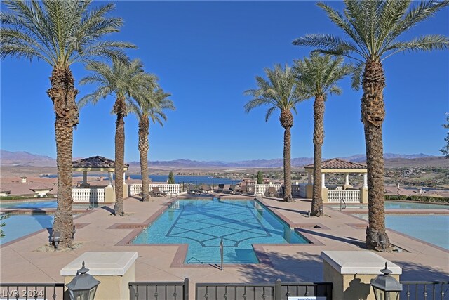 view of pool featuring a patio and a mountain view