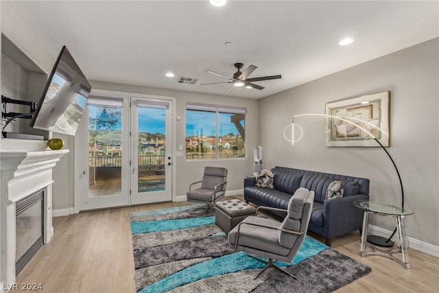 living room with ceiling fan and light wood-type flooring