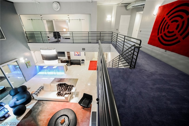 kitchen with white cabinetry and a towering ceiling