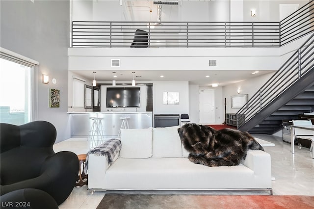 tiled living room with a high ceiling