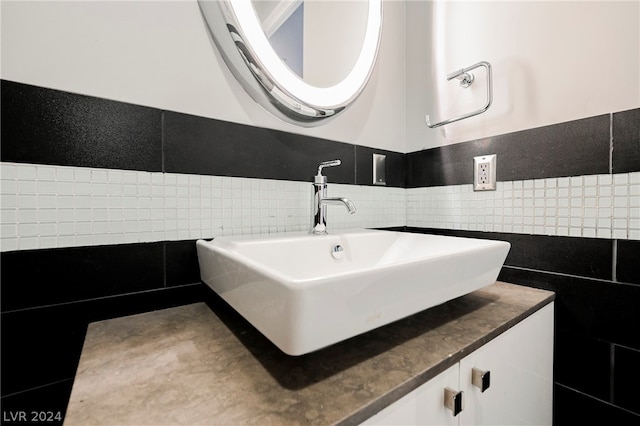 bathroom with tile walls, tasteful backsplash, and vanity