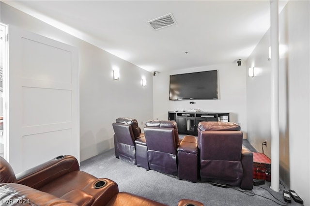 cinema room featuring light colored carpet