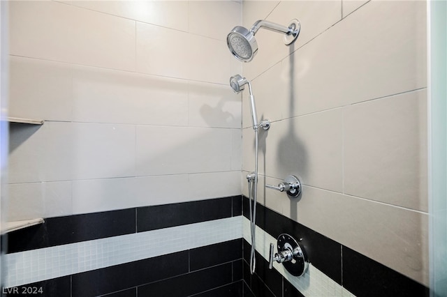 bathroom with tiled shower