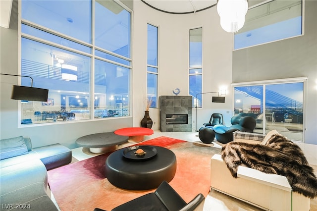 living room with a tiled fireplace and a chandelier