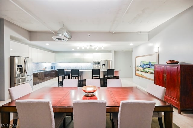 dining room featuring track lighting