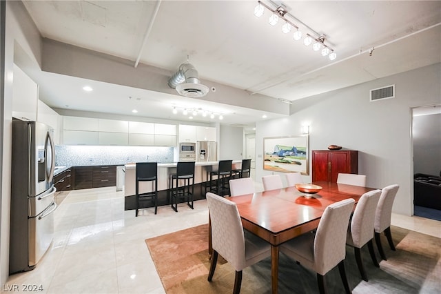 tiled dining room with track lighting