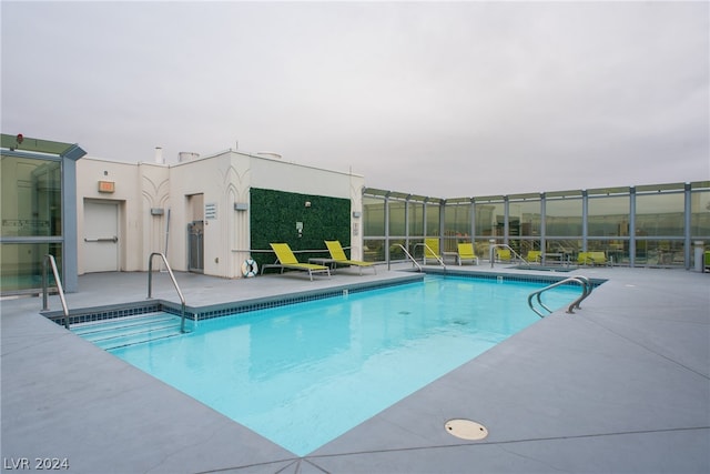 view of swimming pool featuring a patio area