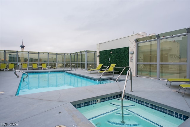 view of pool featuring a patio and a community hot tub