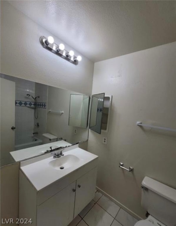 full bathroom with tiled shower / bath combo, vanity, toilet, and tile floors