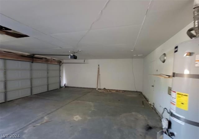 garage with secured water heater and a garage door opener