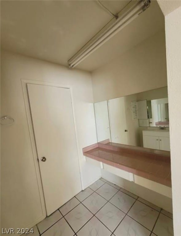 bathroom with vanity and tile flooring