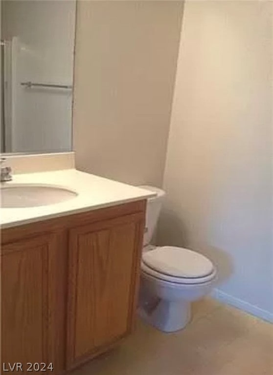 bathroom featuring toilet and oversized vanity