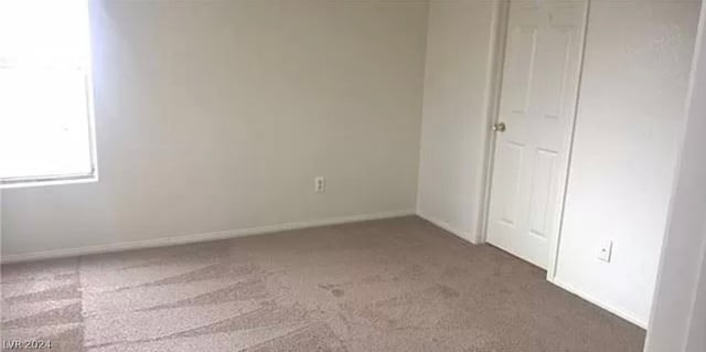 unfurnished bedroom with dark carpet