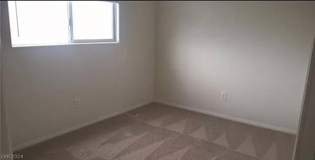 spare room featuring carpet