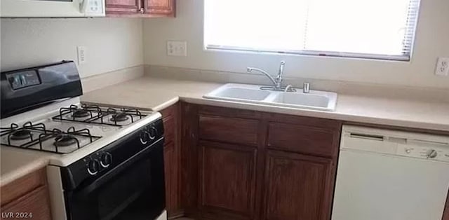 kitchen featuring sink and white appliances