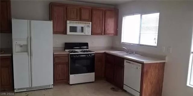 kitchen featuring white appliances and sink