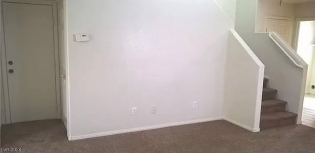 interior space featuring dark colored carpet