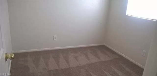 empty room featuring dark colored carpet