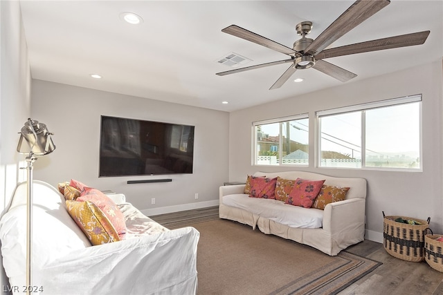 living room featuring visible vents, baseboards, wood finished floors, and recessed lighting