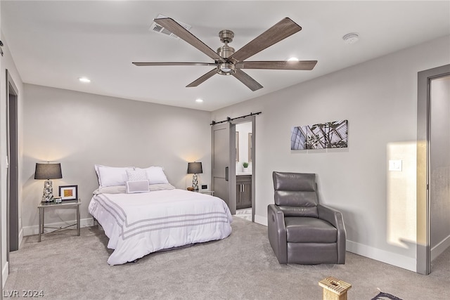 bedroom featuring carpet floors, a barn door, and baseboards