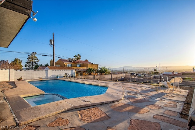 view of pool featuring a pool with connected hot tub, a fenced backyard, and a patio