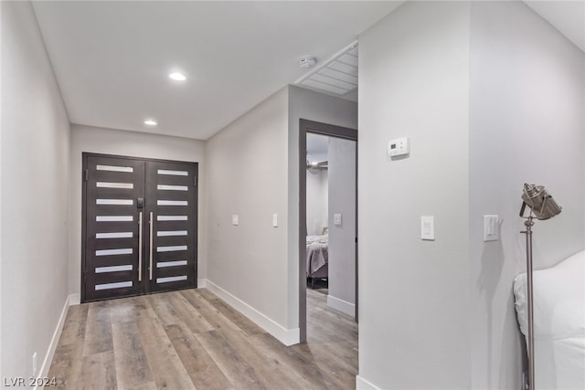 entryway with baseboards, recessed lighting, and light wood-style floors