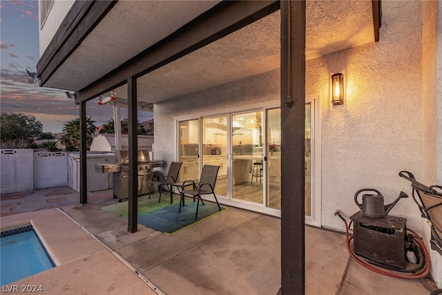 patio terrace at dusk featuring fence