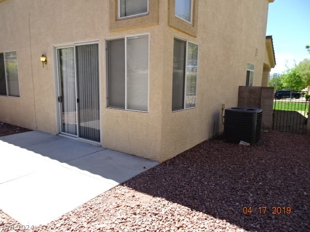 view of side of property featuring central AC and a patio