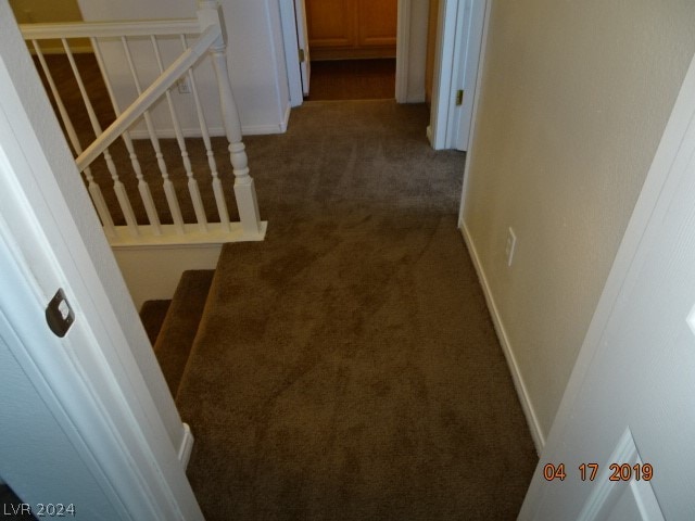 stairway with dark colored carpet