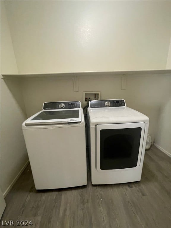 laundry area featuring independent washer and dryer and hardwood / wood-style floors