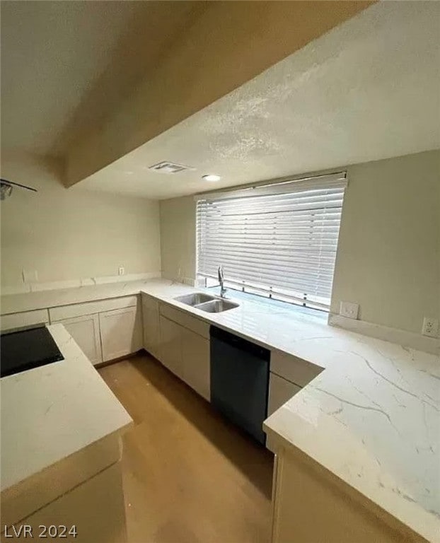 kitchen with black dishwasher, stovetop, sink, and beamed ceiling