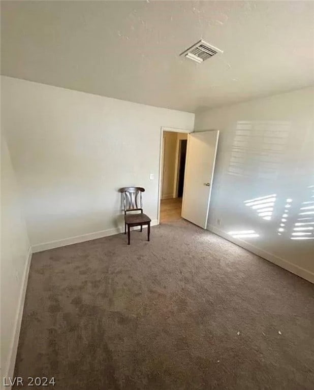 interior space featuring dark colored carpet