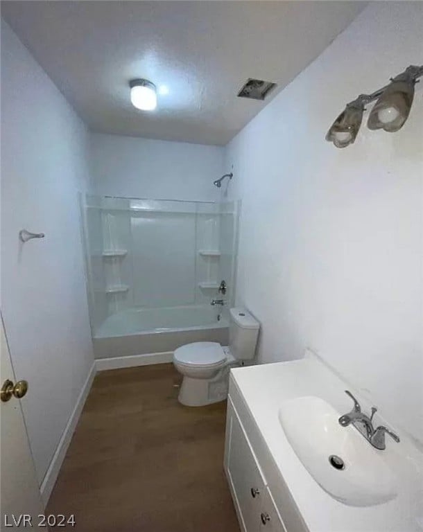 full bathroom featuring shower / washtub combination, toilet, vanity, and wood-type flooring