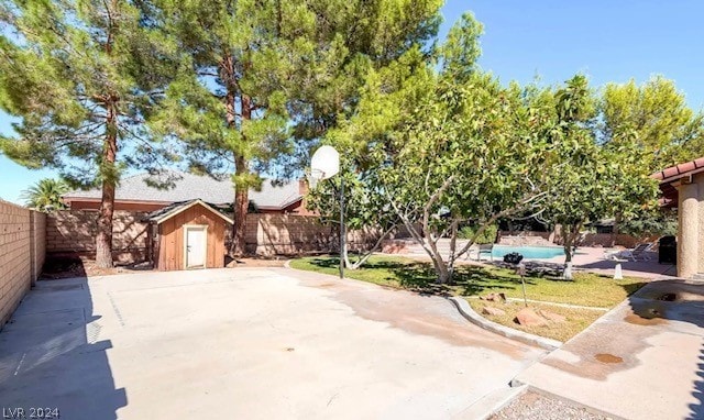 view of front of home with a swimming pool and a patio