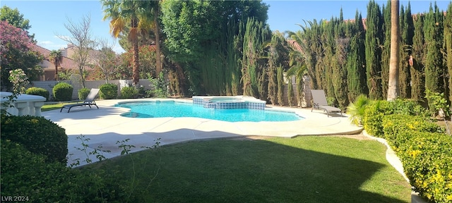 view of swimming pool featuring an in ground hot tub, a patio area, and a lawn