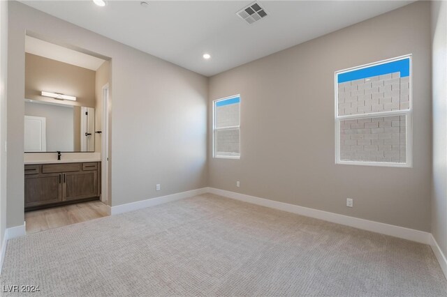 unfurnished room with light colored carpet