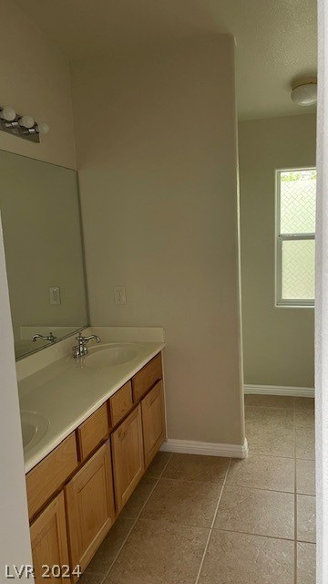 bathroom featuring dual vanity and tile flooring