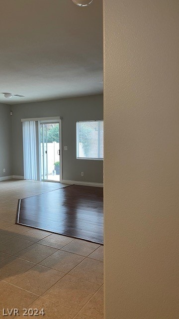 corridor featuring light tile flooring