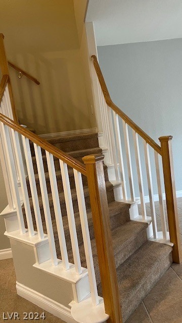 stairs with dark tile flooring