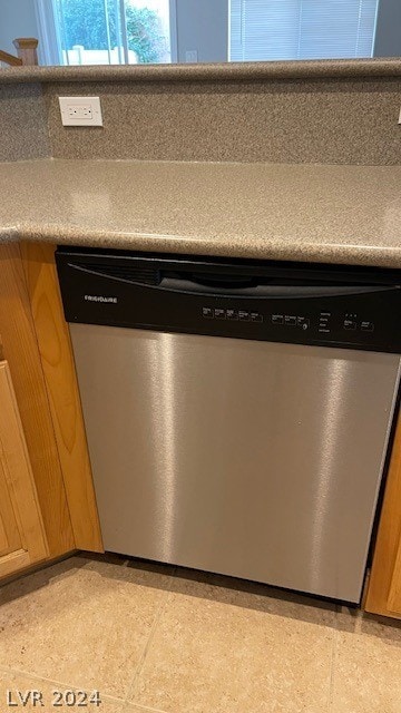 room details with light tile flooring and stainless steel dishwasher