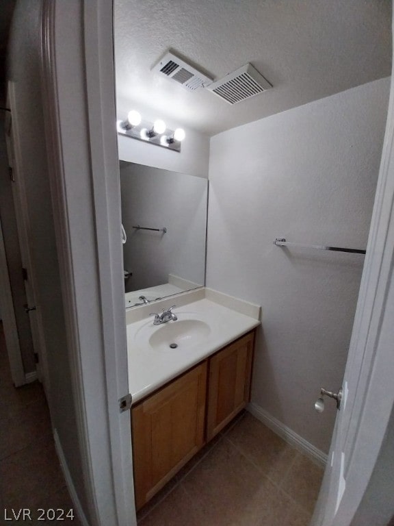 bathroom with vanity and tile floors