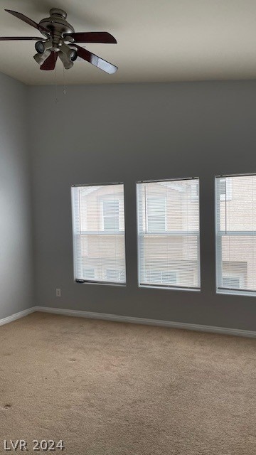 carpeted empty room with ceiling fan