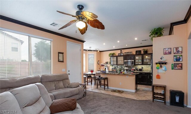 living room with light tile patterned floors, light colored carpet, visible vents, ceiling fan, and ornamental molding