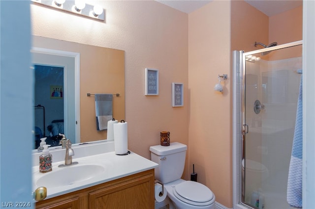 bathroom featuring a stall shower, vanity, and toilet