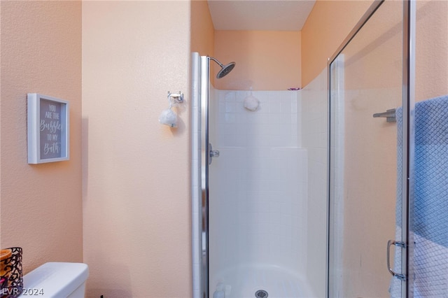 bathroom with walk in shower and toilet