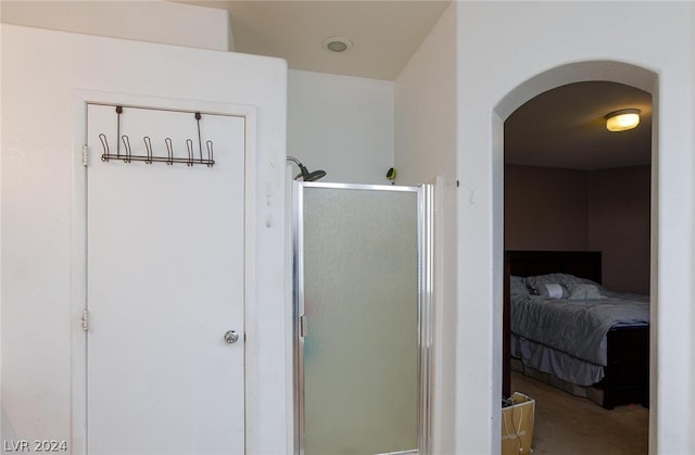 bathroom featuring a shower stall and ensuite bathroom