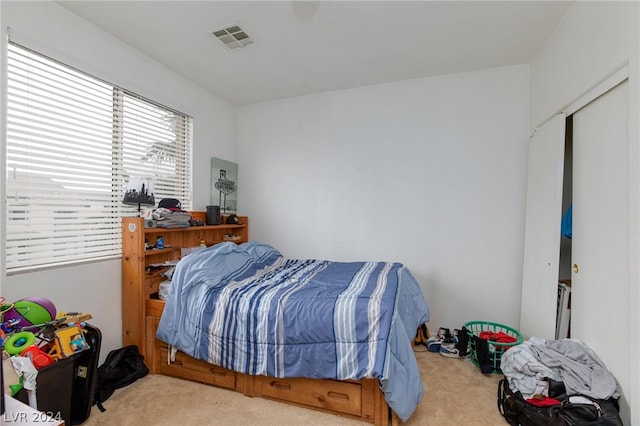 bedroom with light colored carpet