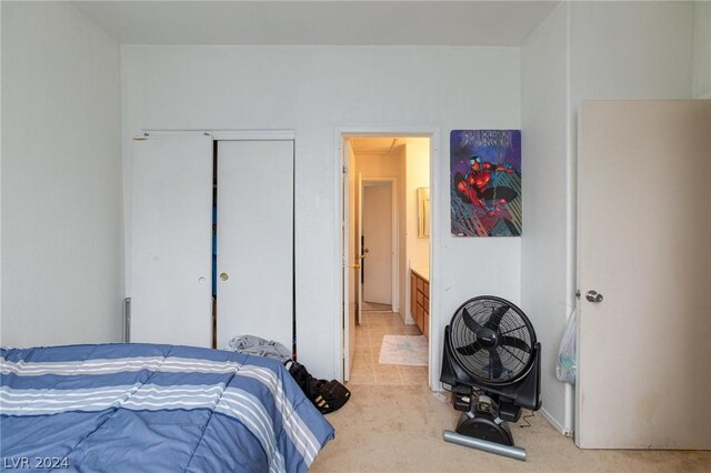 bedroom with ensuite bath, attic access, a closet, and light colored carpet