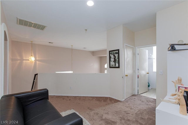 living area with carpet floors and visible vents