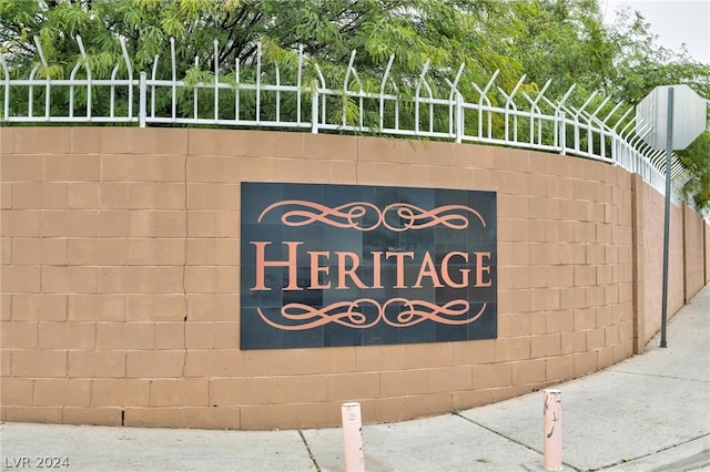 community sign featuring fence